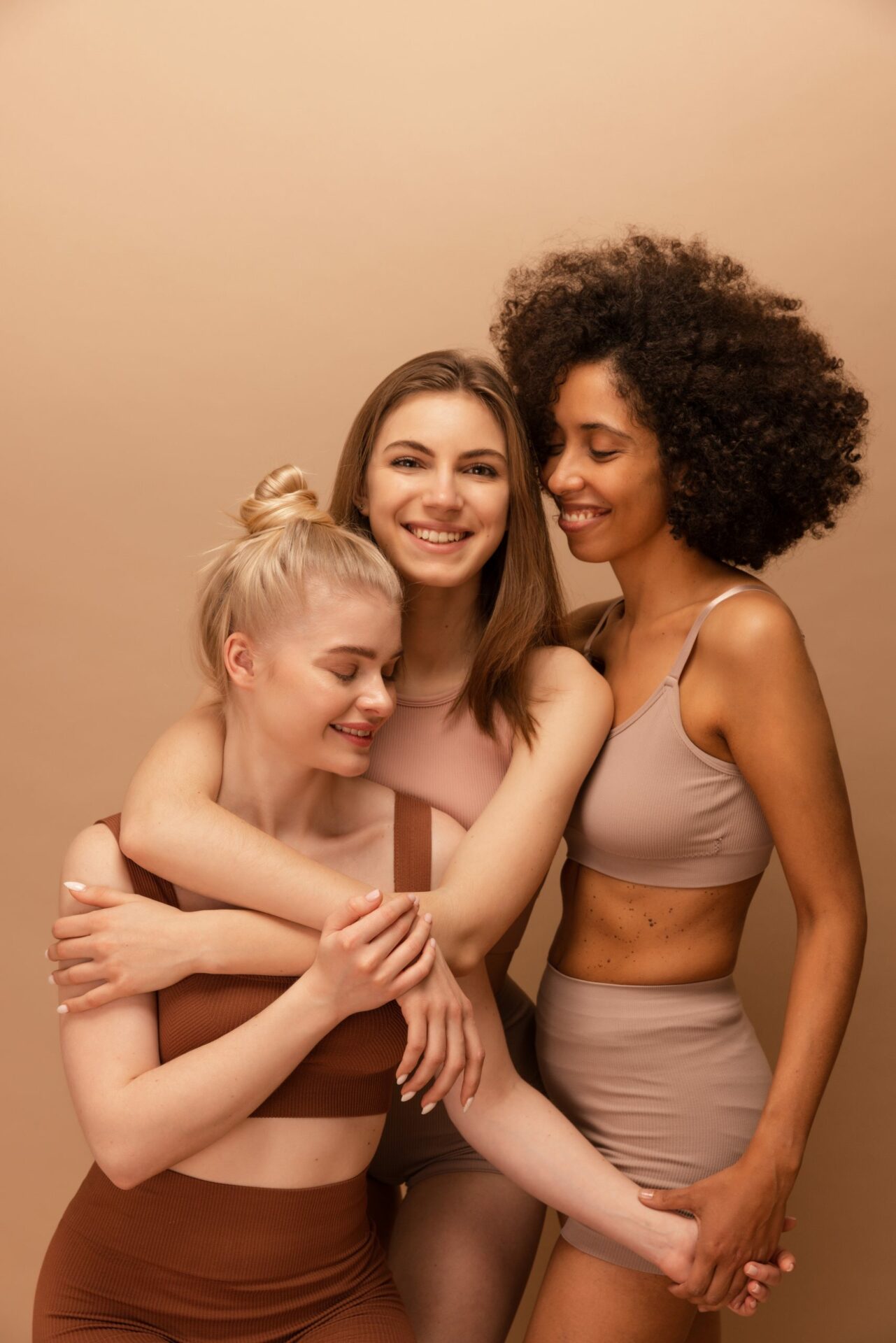 photo-shows-three-young-diverse-girls-wearing-top-leggings-spending-time-together-beige-background